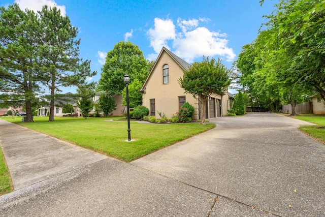 1073 Woodland Glen Dr, Cordova, TN 38018 - view of property exterior featuring a garage, driveway, and stucco siding