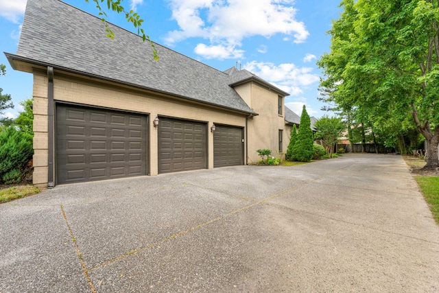 1073 Woodland Glen Dr, Cordova, TN 38018 - view of property exterior with driveway, roof with shingles, and an attached garage