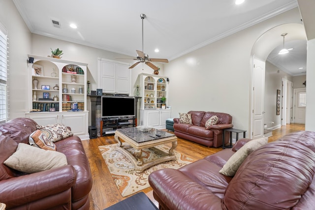 1073 Woodland Glen Dr, Cordova, TN 38018 - living area with ceiling fan, light wood-style floors, arched walkways, ornamental molding, and recessed lighting