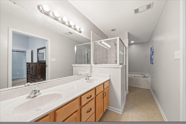 1360 Broadstone Cv, Cordova, TN 38016 - full bath with tile patterned flooring, a garden tub, a shower stall, double vanity, and a textured ceiling
