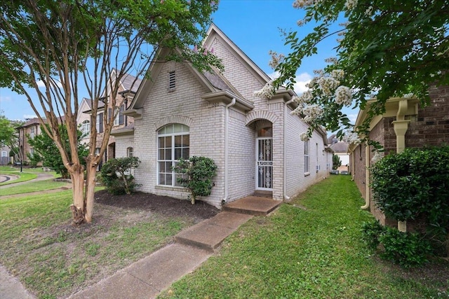 1360 Broadstone Cv, Cordova, TN 38016 - view of front facade featuring a front yard and brick siding
