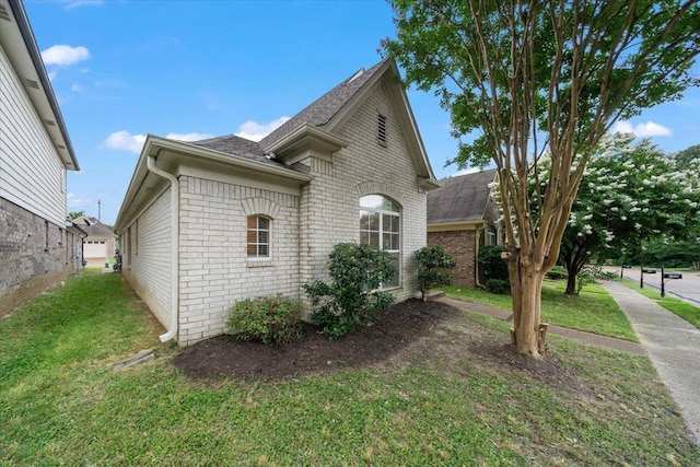 1360 Broadstone Cv, Cordova, TN 38016 - view of side of property featuring brick siding, a yard, and roof with shingles