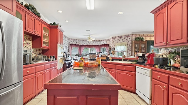 9573 Wolf River Blvd, Germantown, TN 38139 - kitchen featuring stainless steel appliances, light tile patterned floors, a sink, wallpapered walls, and a ceiling fan