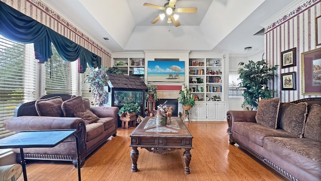 9573 Wolf River Blvd, Germantown, TN 38139 - living area with ceiling fan, wood finished floors, built in features, and a tile fireplace