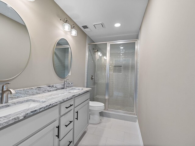 712 Lawncrest Cv, Collierville, TN 38017 - full bathroom featuring toilet, double vanity, tile patterned flooring, a shower stall, and recessed lighting