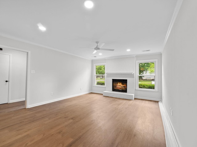 712 Lawncrest Cv, Collierville, TN 38017 - unfurnished living room featuring ornamental molding, wood finished floors, healthy amount of natural light, recessed lighting, and a fireplace