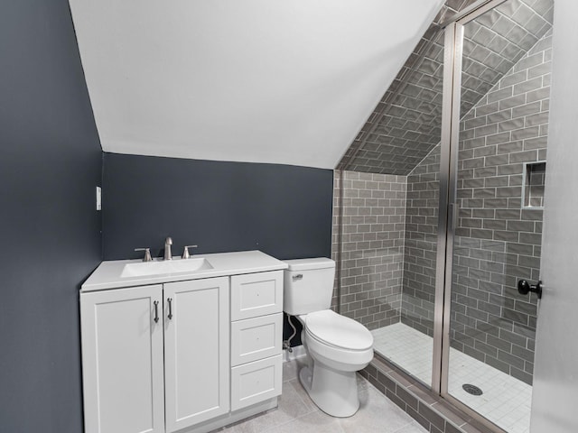712 Lawncrest Cv, Collierville, TN 38017 - full bath featuring lofted ceiling, toilet, a shower stall, vanity, and tile patterned floors