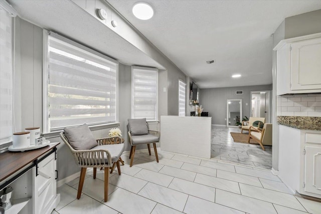 3266 Dothan St, Memphis, TN 38118 - kitchen with white cabinets, baseboards, and tasteful backsplash