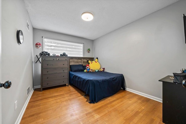3266 Dothan St, Memphis, TN 38118 - bedroom featuring wood finished floors, baseboards, and a textured ceiling