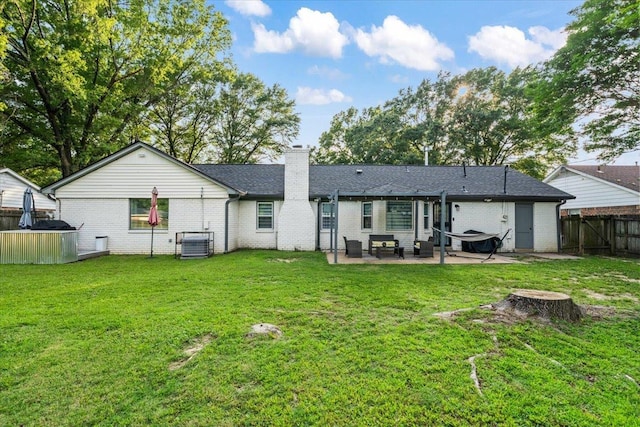 3266 Dothan St, Memphis, TN 38118 - rear view of property with a patio, a chimney, and brick siding