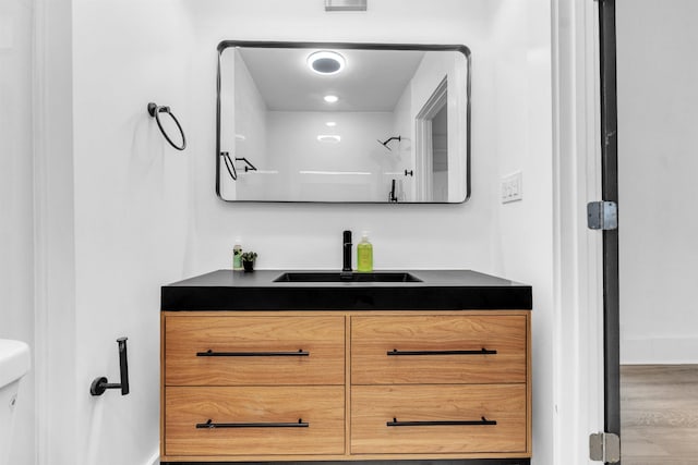 1721 Nelson Ave, Memphis, TN 38114 - bathroom with vanity, wood finished floors, and toilet