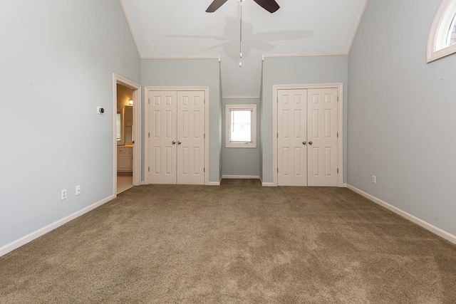1570 Eastmoreland Ave, Memphis, TN 38104 - unfurnished bedroom with multiple closets, carpet flooring, baseboards, crown molding, and connected bathroom