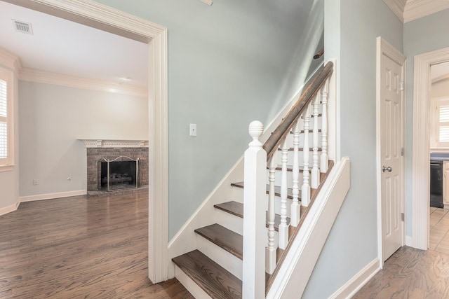 1570 Eastmoreland Ave, Memphis, TN 38104 - stairway featuring wood finished floors, ornamental molding, plenty of natural light, a fireplace, and baseboards
