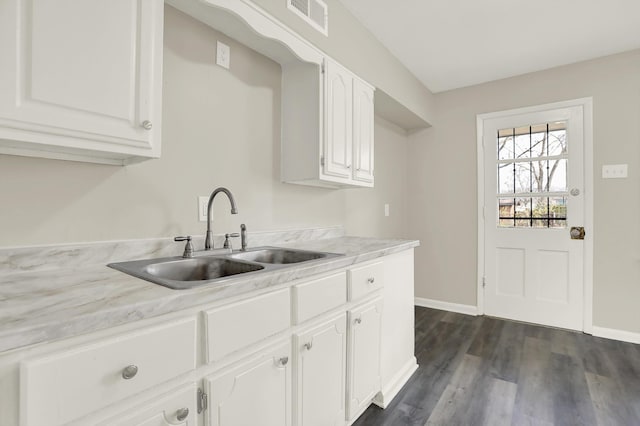 3314 Frayser View Dr, Memphis, TN 38127 - kitchen with a sink, light countertops, white cabinets, baseboards, and dark wood finished floors