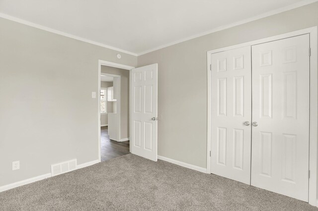 3314 Frayser View Dr, Memphis, TN 38127 - unfurnished bedroom featuring dark colored carpet, baseboards, crown molding, and a closet