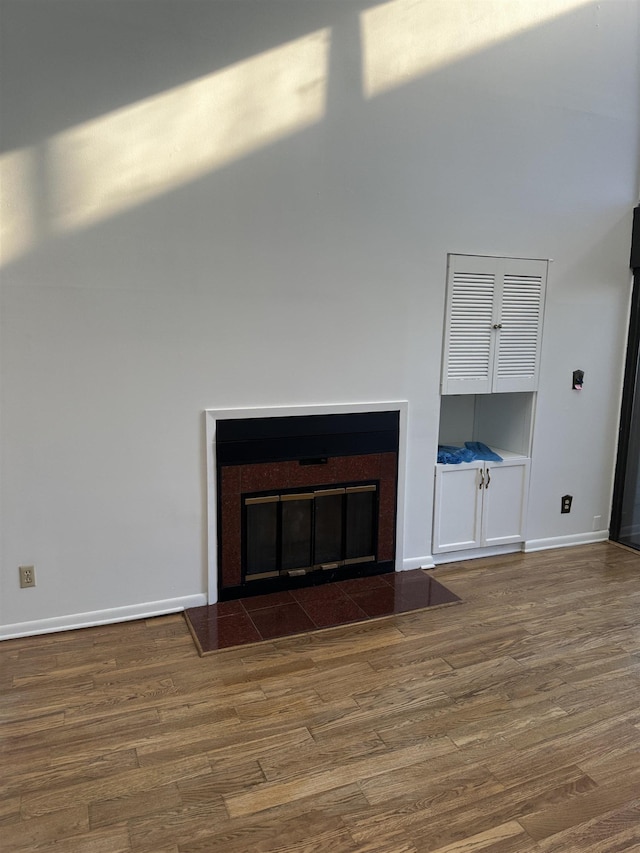 373 Riverbluff Pl Unit 3, Memphis, TN 38103 - unfurnished living room with a glass covered fireplace, a high ceiling, wood finished floors, and baseboards