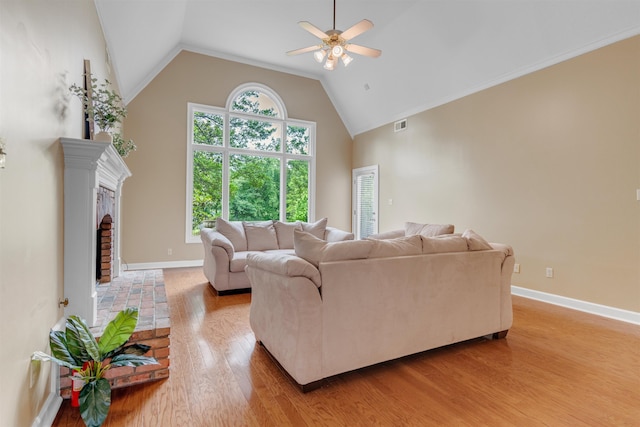 2660 Dibrell Trail Dr, Collierville, TN 38017 - living area featuring a ceiling fan, light wood-style flooring, a fireplace, baseboards, and high vaulted ceiling