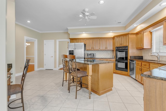 2660 Dibrell Trail Dr, Collierville, TN 38017 - kitchen with black appliances, a sink, light tile patterned floors, a kitchen bar, and crown molding
