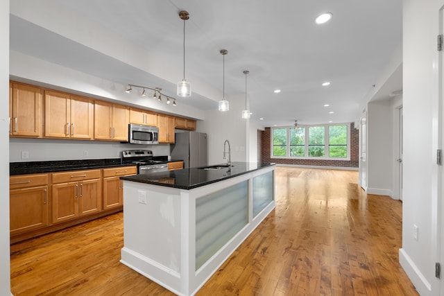 123 Court Ave Unit 401, Memphis, TN 38103 - kitchen with appliances with stainless steel finishes, a sink, recessed lighting, light wood-style flooring, and a kitchen island with sink