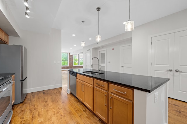123 Court Ave Unit 401, Memphis, TN 38103 - kitchen with a sink, appliances with stainless steel finishes, light wood finished floors, recessed lighting, and pendant lighting