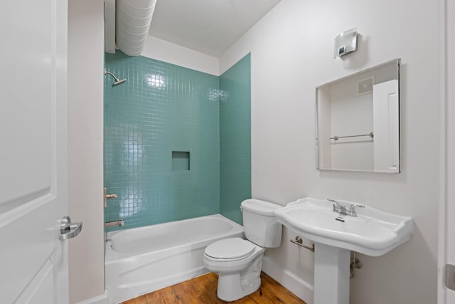123 Court Ave Unit 401, Memphis, TN 38103 - bathroom with wood finished floors, toilet, bathing tub / shower combination, and baseboards