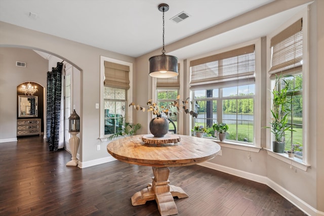 125 Mallard Ln, Rossville, TN 38066 - dining space with arched walkways, plenty of natural light, baseboards, and dark wood-style flooring