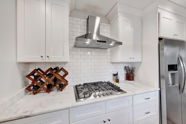 5543 Walnut Grove Rd, Memphis, TN 38120 - kitchen featuring appliances with stainless steel finishes, wall chimney range hood, white cabinets, and decorative backsplash