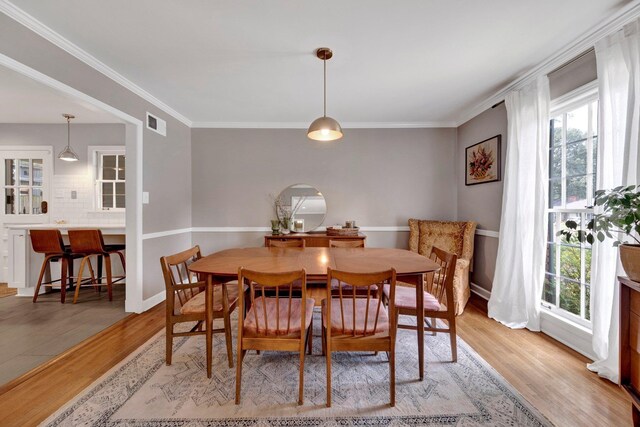 5543 Walnut Grove Rd, Memphis, TN 38120 - dining room featuring plenty of natural light, light wood-style floors, ornamental molding, and baseboards