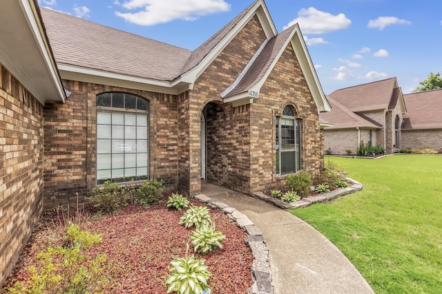 4788 Shadow View Ln, Bartlett, TN 38002 - property entrance with brick siding, a lawn, and a shingled roof