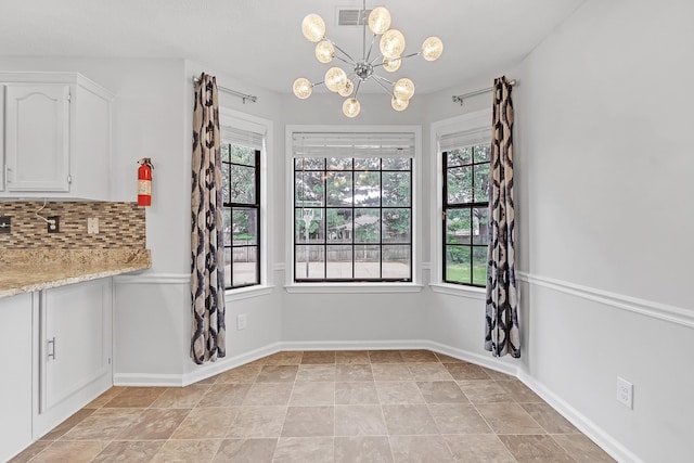 4788 Shadow View Ln, Bartlett, TN 38002 - unfurnished dining area with a chandelier, baseboards, and stone finish flooring