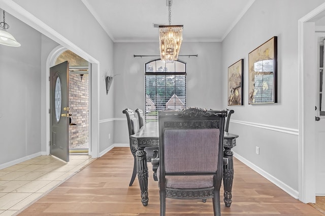 4788 Shadow View Ln, Bartlett, TN 38002 - dining area with a chandelier, crown molding, wood finished floors, and baseboards