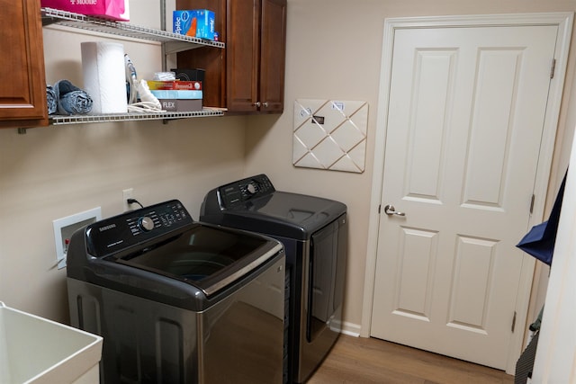 301 Stonevillage Dr W Unit 51, Collierville, TN 38017 - washroom featuring washing machine and clothes dryer, cabinet space, and wood finished floors