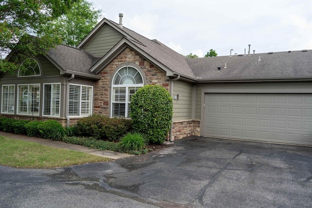 301 Stonevillage Dr W Unit 51, Collierville, TN 38017 - view of front of property with stone siding, asphalt driveway, roof with shingles, and an attached garage