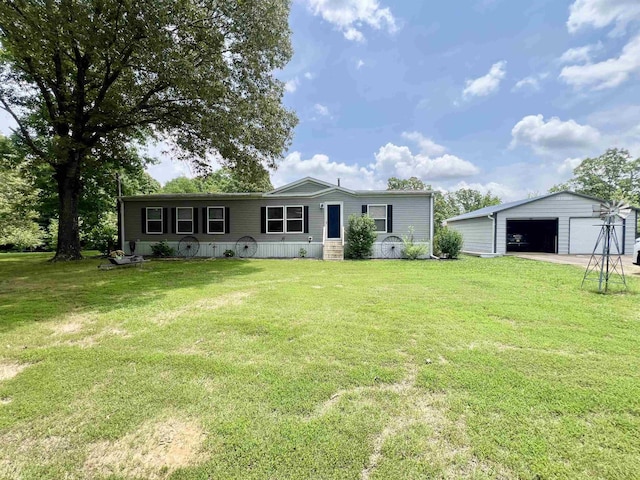 2045 Hardin Graveyard Rd, Adamsville, TN 38310 - view of front of property featuring an outbuilding, a garage, and a front yard