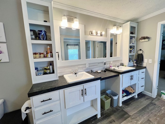 2045 Hardin Graveyard Rd, Adamsville, TN 38310 - bathroom with ornamental molding, double vanity, tasteful backsplash, wood finished floors, and a textured ceiling
