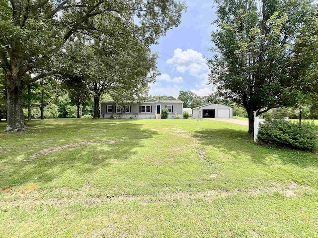 2045 Hardin Graveyard Rd, Adamsville, TN 38310 - view of grassy yard with a garage and an outbuilding