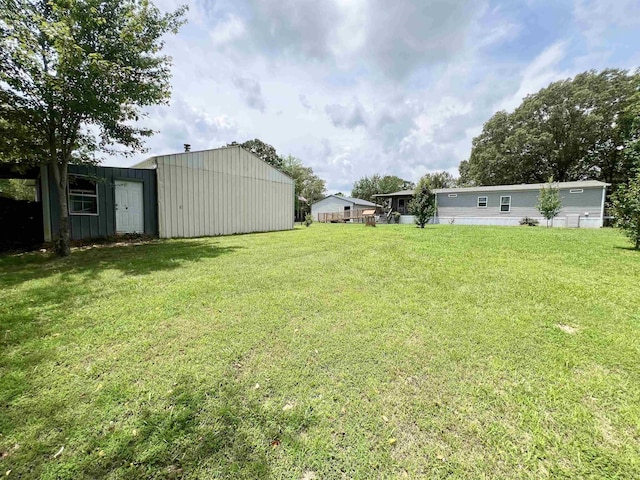 2045 Hardin Graveyard Rd, Adamsville, TN 38310 - view of grassy yard featuring an outbuilding and an outdoor structure