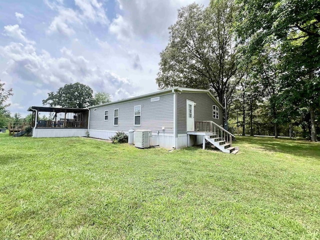2045 Hardin Graveyard Rd, Adamsville, TN 38310 - rear view of property with a lawn, a sunroom, and cooling unit