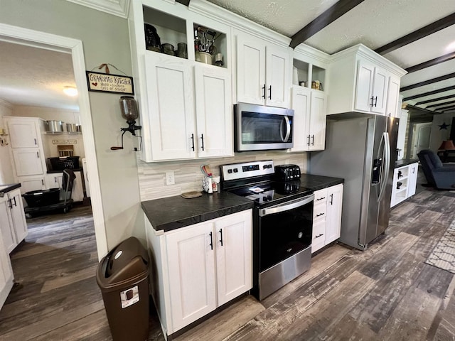 2045 Hardin Graveyard Rd, Adamsville, TN 38310 - kitchen with stainless steel appliances, dark countertops, beamed ceiling, white cabinets, and dark wood-type flooring