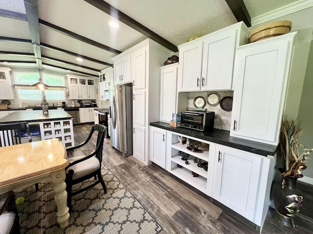 2045 Hardin Graveyard Rd, Adamsville, TN 38310 - kitchen with appliances with stainless steel finishes, white cabinetry, dark countertops, dark wood-style floors, and decorative backsplash