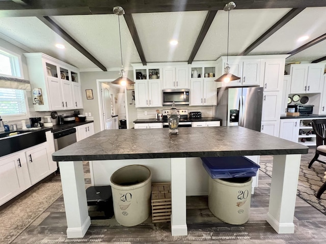 2045 Hardin Graveyard Rd, Adamsville, TN 38310 - kitchen featuring dark countertops, stainless steel appliances, recessed lighting, a breakfast bar, and beamed ceiling