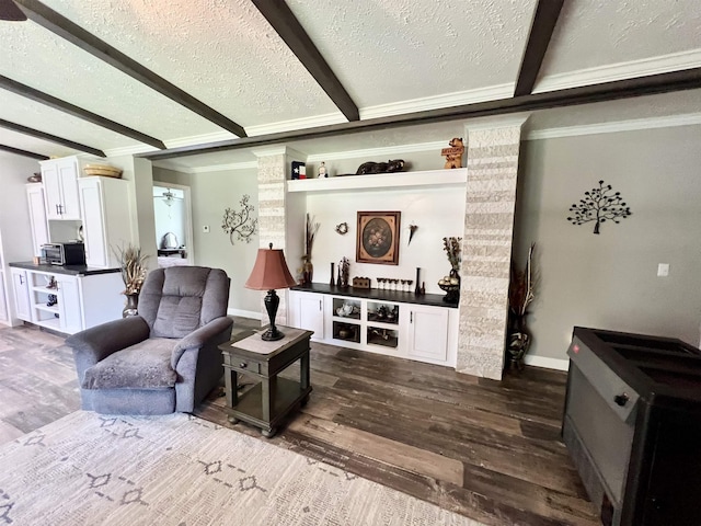 2045 Hardin Graveyard Rd, Adamsville, TN 38310 - living area with dark wood-type flooring, crown molding, beam ceiling, a textured ceiling, and baseboards