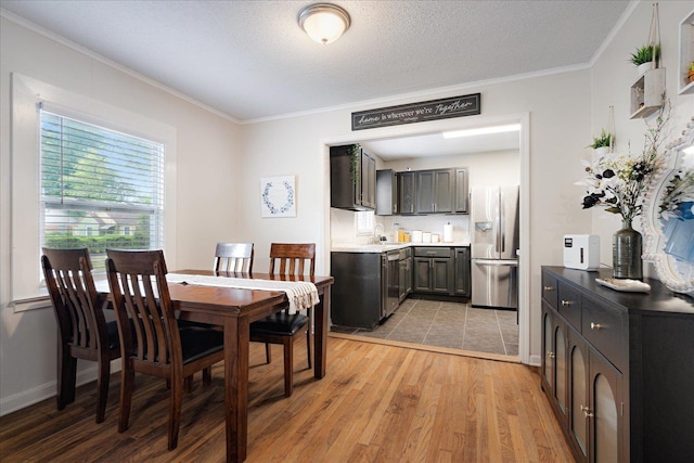 1159 Echles St, Memphis, TN 38111 - dining area featuring crown molding, light wood-style floors, and baseboards