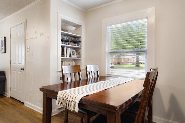 1159 Echles St, Memphis, TN 38111 - dining space featuring crown molding, wood finished floors, and baseboards