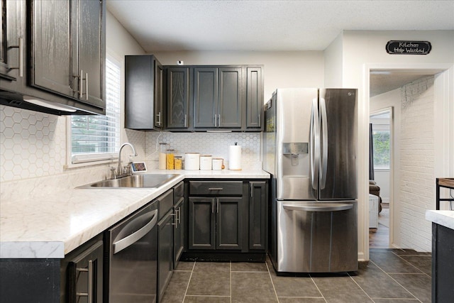 1159 Echles St, Memphis, TN 38111 - kitchen featuring stainless steel appliances, a sink, tasteful backsplash, light countertops, and dark tile patterned floors