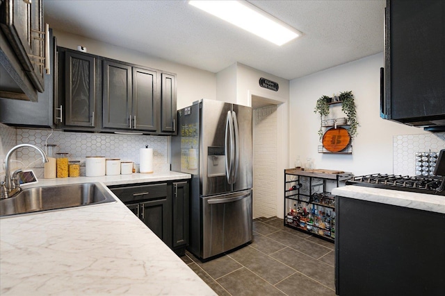 1159 Echles St, Memphis, TN 38111 - kitchen featuring stainless steel fridge, a sink, light countertops, decorative backsplash, and dark tile patterned flooring