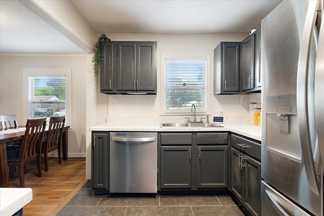 1159 Echles St, Memphis, TN 38111 - kitchen featuring appliances with stainless steel finishes, a sink, light countertops, tasteful backsplash, and ornamental molding