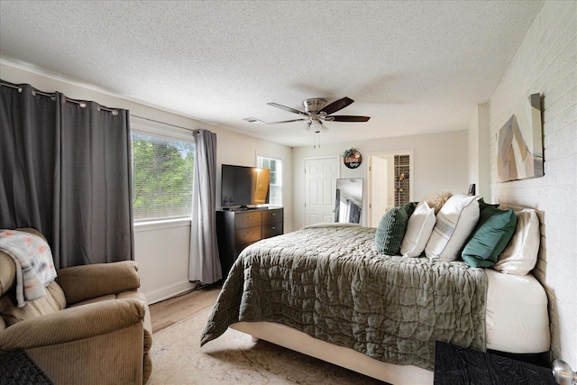 1159 Echles St, Memphis, TN 38111 - bedroom with light wood-style floors, a textured ceiling, and a ceiling fan