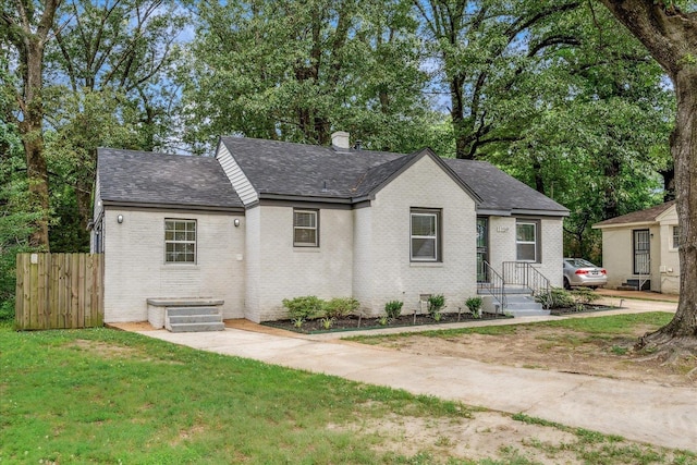1159 Echles St, Memphis, TN 38111 - view of front of house with brick siding, roof with shingles, and a chimney