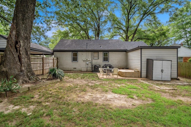 1159 Echles St, Memphis, TN 38111 - back of house featuring a garage, a patio, central air condition unit, and roof with shingles